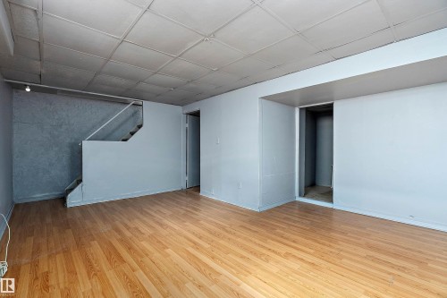Finished basement featuring light wood finished floors and a paneled ceiling - 15C Callingwood Crest, Edmonton, AB - Indoor Photo Showing Other Room