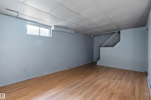 Basement with light wood-style flooring and a paneled ceiling - 15C Callingwood Crest, Edmonton, AB - Indoor