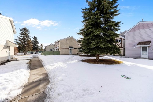 Yard covered in snow with a residential view - 15C Callingwood Crest, Edmonton, AB - Outdoor