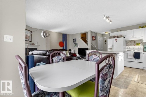 Dining room featuring a textured ceiling and light floors - 23 4020 21 Street, Edmonton, AB - Indoor