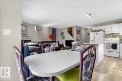 Dining room featuring a textured ceiling and light floors - 