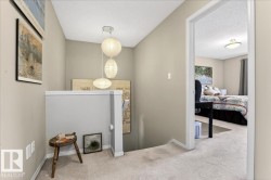 Carpeted entrance foyer with a textured ceiling and baseboards - 
