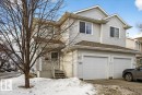 View of front of home with an attached garage, roof with shingles, and driveway - 23 4020 21 Street, Edmonton, AB  - Outdoor With Facade 