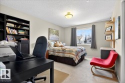 Carpeted bedroom with an office area and a textured ceiling - 