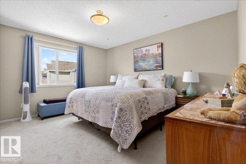 Carpeted bedroom featuring a textured ceiling - 23 4020 21 Street, Edmonton, AB - Indoor Photo Showing Bedroom