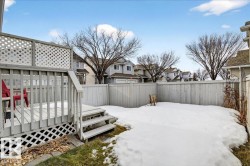 Fenced backyard featuring a residential view and a wooden deck - 