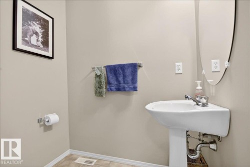 Half bathroom featuring baseboards and a sink - 23 4020 21 Street, Edmonton, AB - Indoor Photo Showing Bathroom