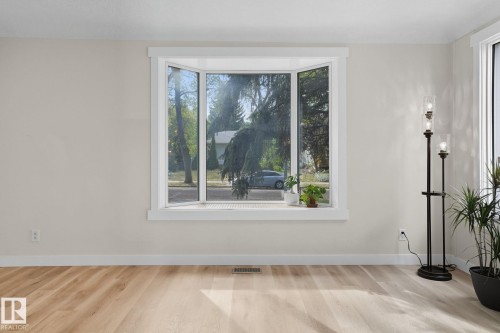 Unfurnished dining area featuring wood finished floors and healthy amount of natural light - 11222 71 Avenue, Edmonton, AB - Indoor Photo Showing Other Room