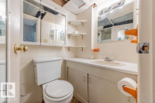 Bathroom featuring toilet and vanity - 12253 95A Street, Edmonton, AB - Indoor Photo Showing Bathroom