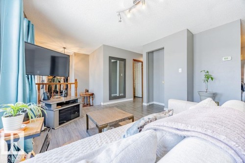 Bedroom with a textured ceiling and wood finished floors - 12253 95A Street, Edmonton, AB - Indoor Photo Showing Bedroom