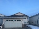 View of front of home with an attached garage, driveway, and a shingled roof - 3011 37 Street Nw, Edmonton, AB  - Outdoor 