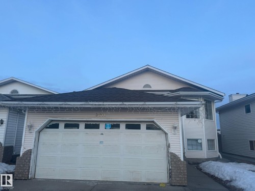 View of side of property with a garage, roof with shingles, and driveway - 3011 37 Street Nw, Edmonton, AB - Outdoor
