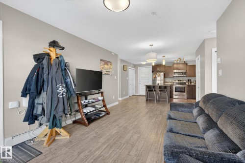 Living area with light wood finished floors and baseboards - 104 8515 99 Street, Edmonton, AB - Indoor