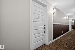 Hall featuring carpet floors and baseboards - 