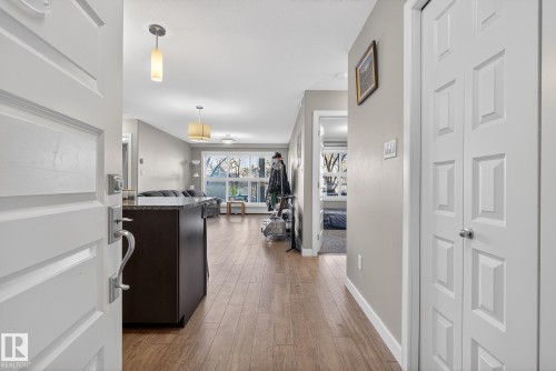 Corridor featuring light wood-style floors and baseboards - 104 8515 99 Street, Edmonton, AB - Indoor Photo Showing Other Room