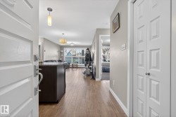 Corridor featuring light wood-style floors and baseboards - 