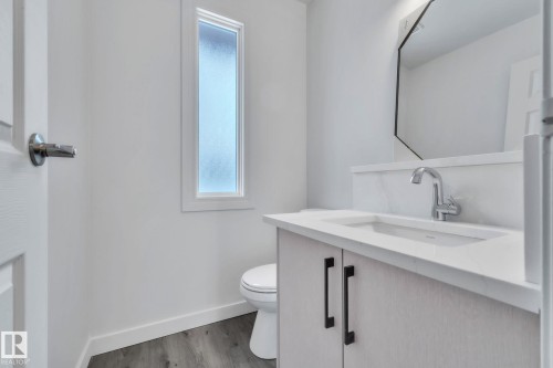 Bathroom featuring vanity and light wood-type flooring - 1281 Hooke Road, Edmonton, AB - Indoor Photo Showing Bathroom