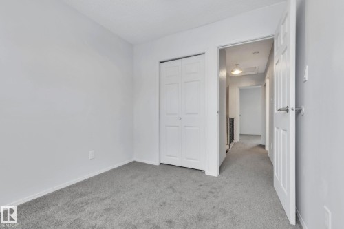 Unfurnished bedroom with light carpet and a closet - 1281 Hooke Road, Edmonton, AB - Indoor Photo Showing Other Room