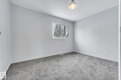 Unfurnished room with carpet and a textured ceiling - 1281 Hooke Road, Edmonton, AB - Indoor Photo Showing Other Room