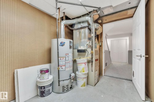 Utilities featuring gas water heater and heating unit - 1281 Hooke Road, Edmonton, AB - Indoor Photo Showing Basement