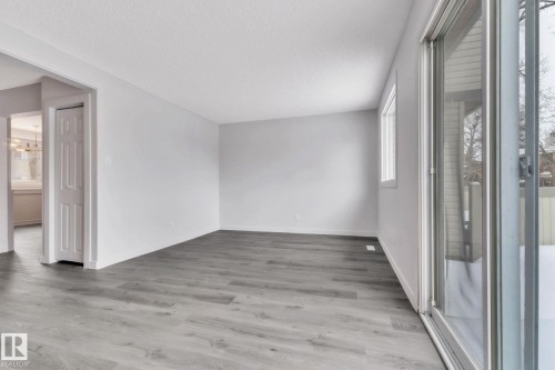 Unfurnished room with light wood finished floors and a textured ceiling - 1281 Hooke Road, Edmonton, AB - Indoor Photo Showing Other Room