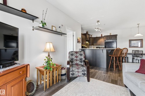 Living area with dark wood finished floors - 313 263 Macewan Road, Edmonton, AB - Indoor Photo Showing Living Room