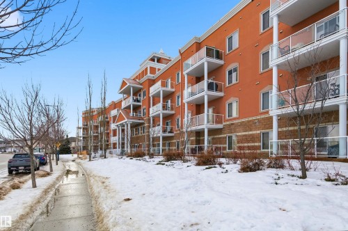 Snow covered building featuring a view of apartment building / complex - 313 263 Macewan Road, Edmonton, AB - Outdoor With Facade