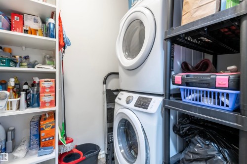 Laundry room featuring stacked washer / dryer - 313 263 Macewan Road, Edmonton, AB - Indoor Photo Showing Laundry Room