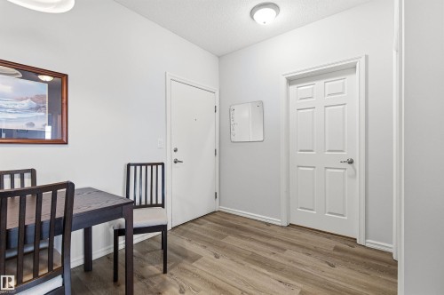 Dining area with a textured ceiling and light wood finished floors - 313 263 Macewan Road, Edmonton, AB - Indoor