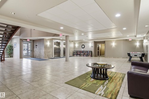 Building lobby with wainscoting and recessed lighting - 313 263 Macewan Road, Edmonton, AB - Indoor Photo Showing Other Room