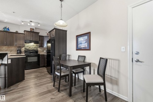 Dining room with light wood finished floors and vaulted ceiling - 313 263 Macewan Road, Edmonton, AB - Indoor