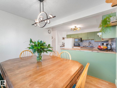 Dining space featuring light wood-style floors and hanging lights - 61 9520 174 Street, Edmonton, AB - Indoor Photo Showing Dining Room