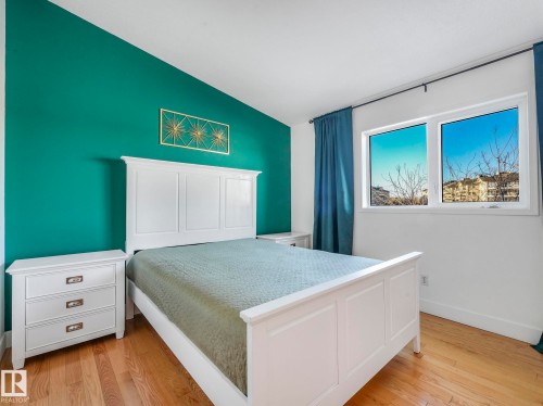 Bedroom with light wood-style floors and lofted ceiling - 61 9520 174 Street, Edmonton, AB - Indoor Photo Showing Bedroom