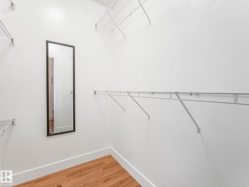 Walk in closet featuring light wood finished floors - 61 9520 174 Street, Edmonton, AB - Indoor With Storage