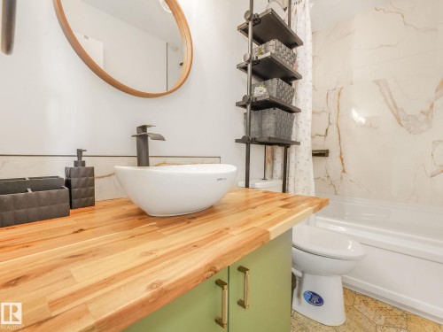 Bathroom with vanity and bathing tub / shower combination - 61 9520 174 Street, Edmonton, AB - Indoor Photo Showing Bathroom