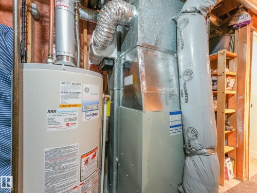 Utilities featuring gas water heater and heating unit - 61 9520 174 Street, Edmonton, AB - Indoor Photo Showing Basement