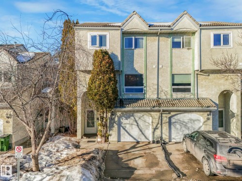 View of front of home featuring an attached garage, a tile roof, driveway, and stucco siding - 61 9520 174 Street, Edmonton, AB - Outdoor