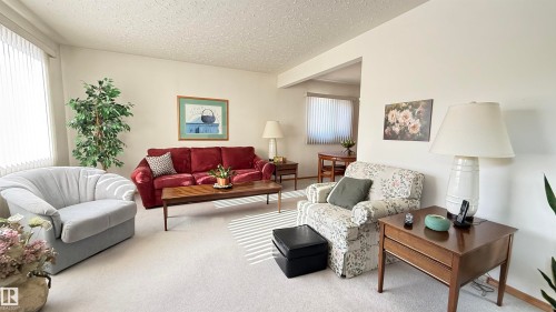 Living room featuring carpet and a textured ceiling - 4608 102 Avenue, Edmonton, AB - Indoor Photo Showing Living Room
