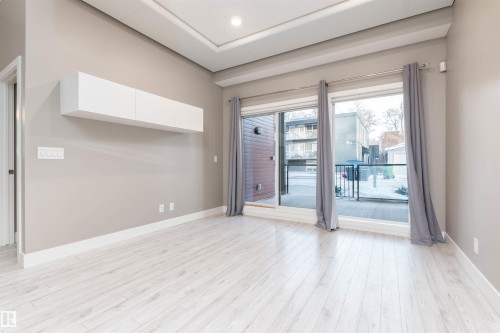 Living room featuring baseboards and light wood-style floors - 105 10006 83 Avenue, Edmonton, AB - Indoor Photo Showing Other Room