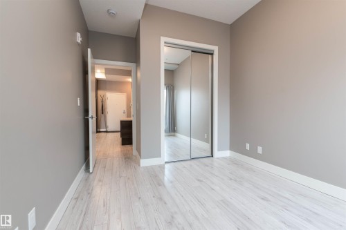 Unfurnished bedroom featuring light wood-style flooring and a closet - 105 10006 83 Avenue, Edmonton, AB - Indoor Photo Showing Other Room