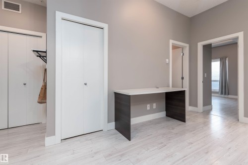 Living room with light wood-style floors and baseboards - 105 10006 83 Avenue, Edmonton, AB - Indoor Photo Showing Other Room