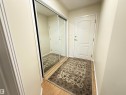 Doorway to outside with ornamental molding and wood finished floors - 302 8215 84 Avenue, Edmonton, AB  - Indoor Photo Showing Other Room 
