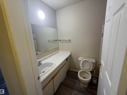 Bathroom featuring vanity and dark wood finished floors - 