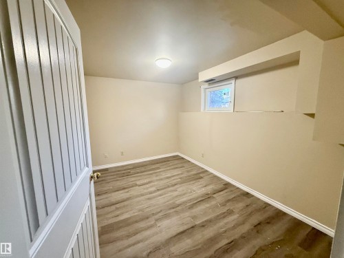 Unfurnished room with wood finished floors and baseboards - 10905 74 Avenue, Edmonton, AB - Indoor Photo Showing Other Room