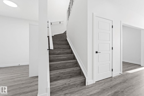 Staircase featuring wood finished floors and baseboards - 3 Pierwyck Loop, Spruce Grove, AB - Indoor Photo Showing Other Room