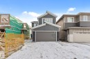 View of front of house with a garage, stone siding, and board and batten siding - 3 Pierwyck Loop, Spruce Grove, AB  - Outdoor 