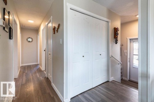 Corridor with a textured ceiling and dark wood finished floors - 4628 46 Ave, Evansburg, AB - Indoor Photo Showing Other Room