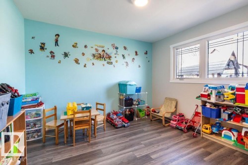 Recreation room with dark wood finished floors - 4628 46 Ave, Evansburg, AB - Indoor