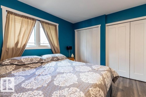 Bedroom with dark wood finished floors and multiple closets - 4628 46 Ave, Evansburg, AB - Indoor Photo Showing Bedroom