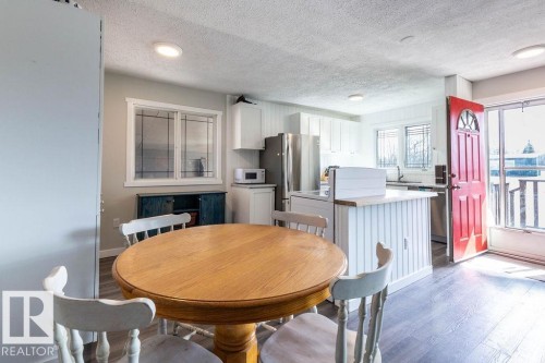 Dining space featuring light wood finished floors and a textured ceiling - 4628 46 Ave, Evansburg, AB - Indoor Photo Showing Dining Room